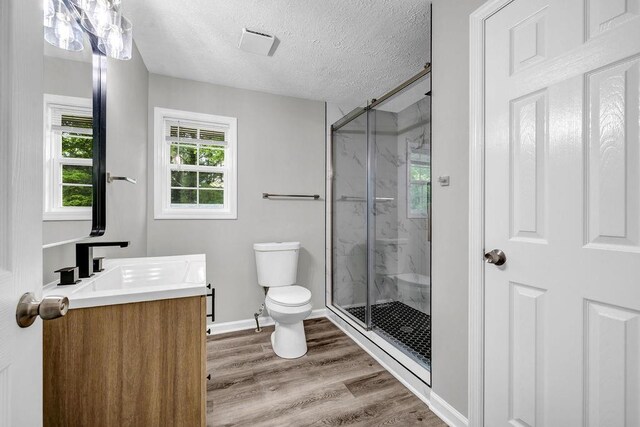 2089 Christian Cir SE, Conyers, GA 30013 - bathroom featuring vanity, a marble finish shower, wood finished floors, and a textured ceiling