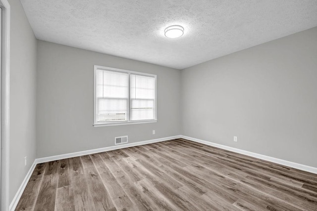2089 Christian Cir SE, Conyers, GA 30013 - spare room with a textured ceiling and wood finished floors