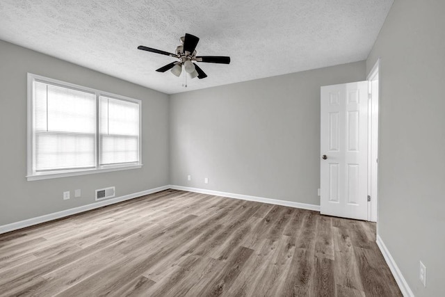 2089 Christian Cir SE, Conyers, GA 30013 - spare room featuring a textured ceiling, wood finished floors, and ceiling fan