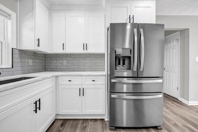 2089 Christian Cir SE, Conyers, GA 30013 - kitchen featuring stainless steel refrigerator with ice dispenser, light wood-style floors, and white cabinets