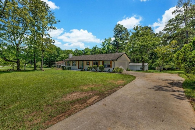 2089 Christian Cir SE, Conyers, GA 30013 - ranch-style home with a front yard, driveway, a garage, and a chimney