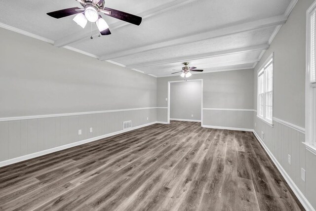 2089 Christian Cir SE, Conyers, GA 30013 - spare room with beamed ceiling, wood finished floors, ceiling fan, and wainscoting