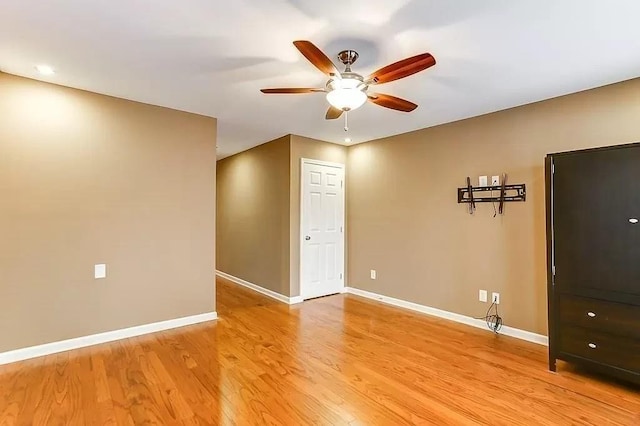 spare room with ceiling fan and light hardwood / wood-style floors