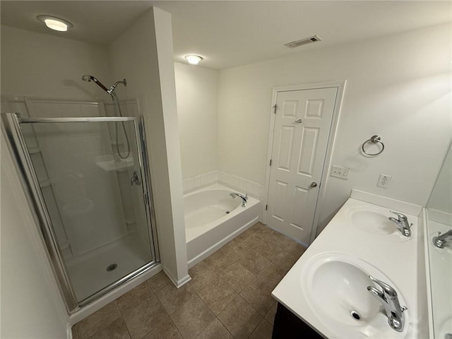 full bathroom featuring visible vents, double vanity, a sink, a shower stall, and a bath