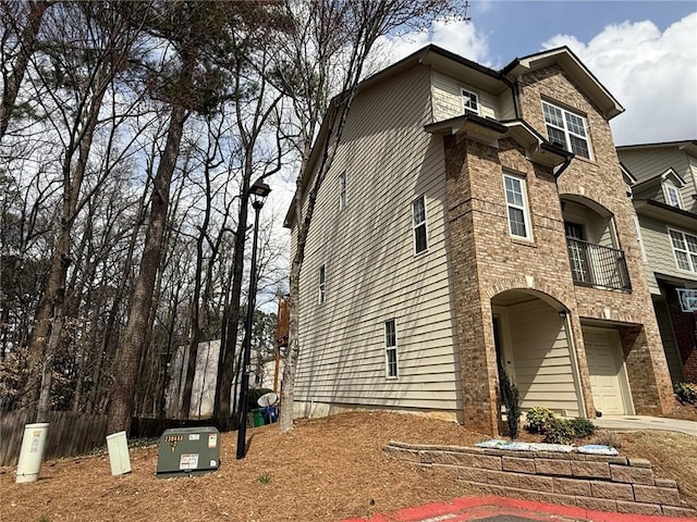 view of side of property featuring a garage and driveway