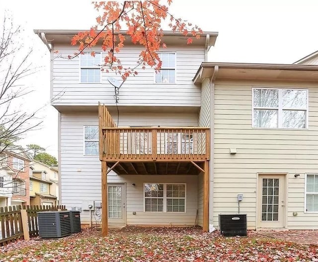 rear view of property with central AC unit and a balcony