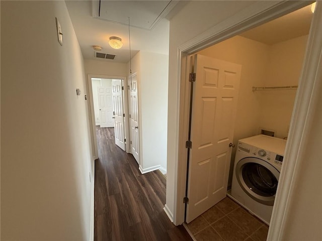 clothes washing area with dark wood-style floors, visible vents, attic access, laundry area, and washer / clothes dryer