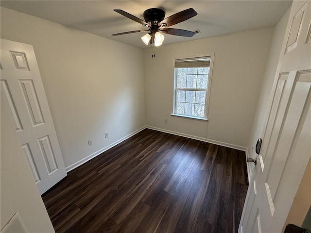 unfurnished bedroom featuring dark wood finished floors, a ceiling fan, and baseboards