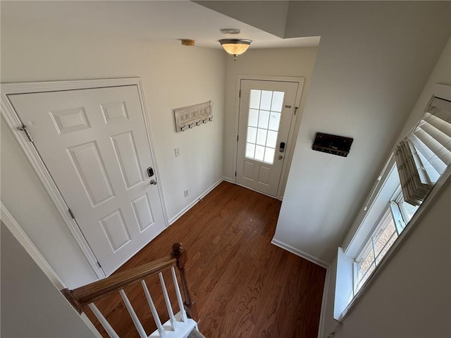 doorway to outside featuring stairs, baseboards, and dark wood-style flooring