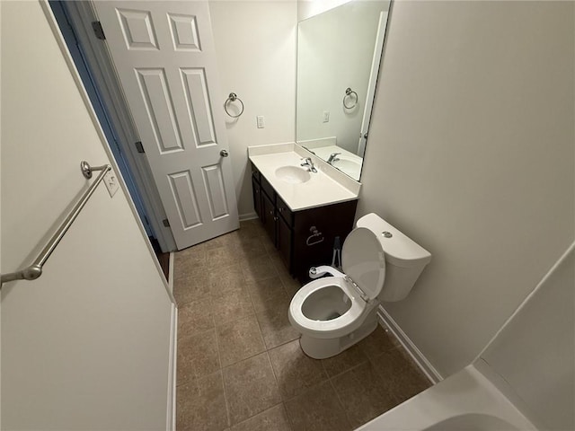 bathroom with tile patterned floors, toilet, vanity, and baseboards