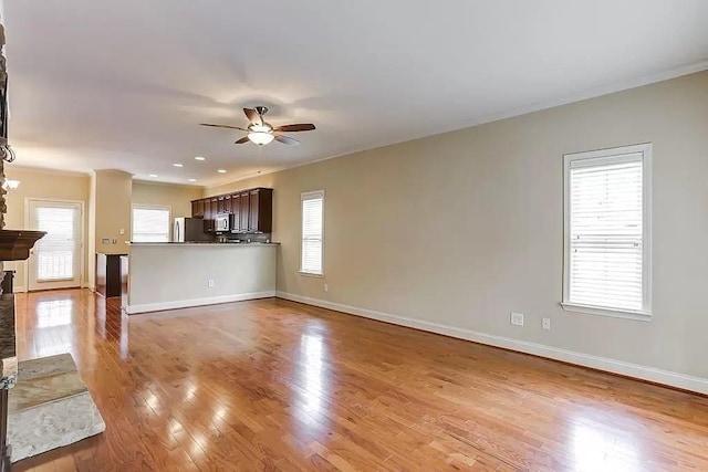 unfurnished living room featuring light hardwood / wood-style floors and ceiling fan