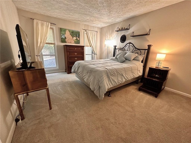 bedroom featuring a textured ceiling and light carpet