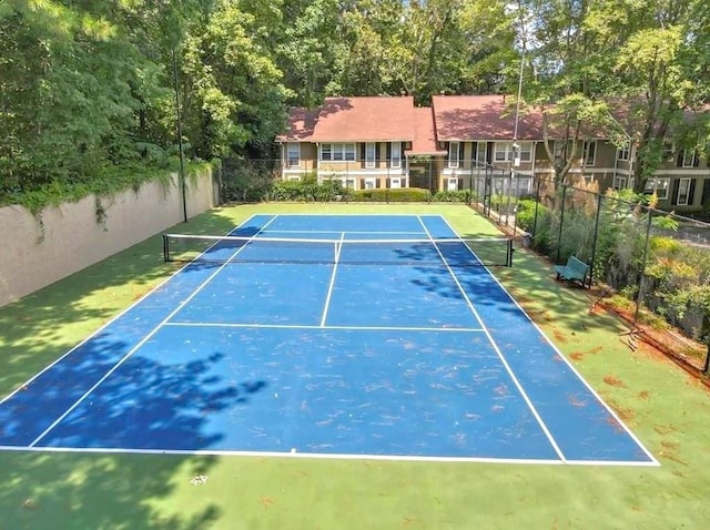 view of tennis court featuring basketball hoop