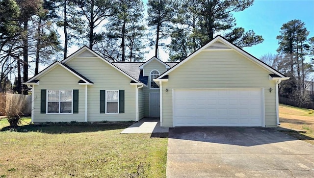 ranch-style home featuring a front lawn, a garage, and driveway