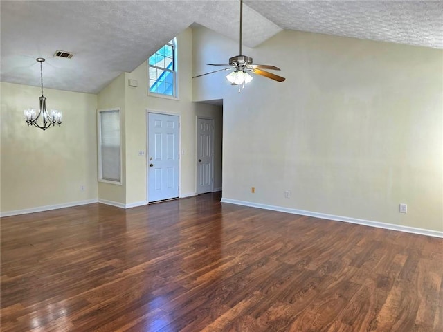 unfurnished living room with visible vents, ceiling fan with notable chandelier, dark wood-type flooring, and baseboards