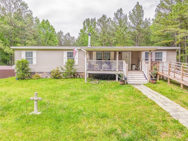 manufactured / mobile home featuring covered porch and a front lawn