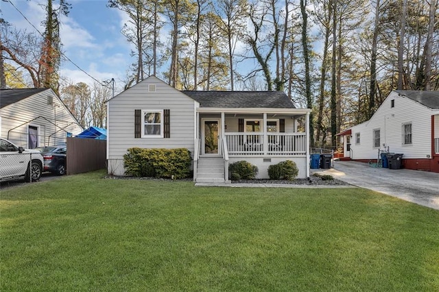 2912 Palm Dr, East Point, GA 30344 - view of front of house featuring covered porch, a front yard, and a shingled roof
