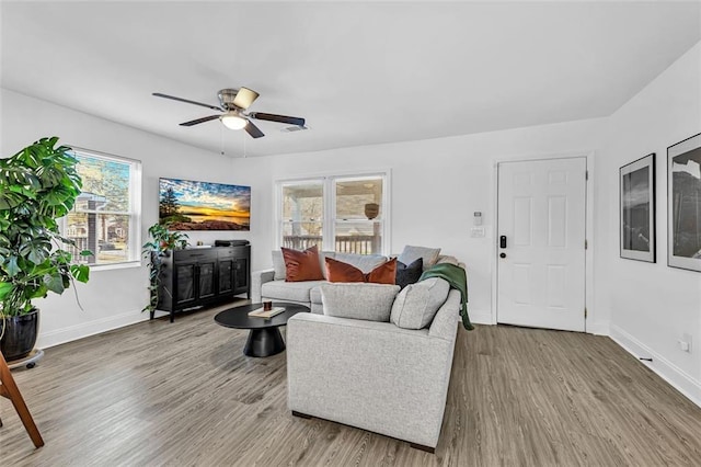 2912 Palm Dr, East Point, GA 30344 - living area with a ceiling fan, wood finished floors, and plenty of natural light