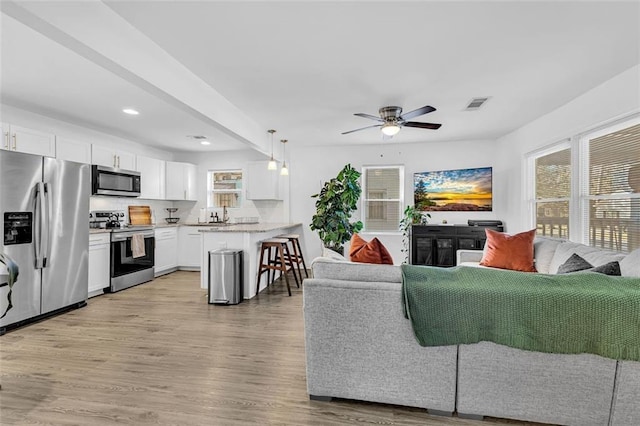 2912 Palm Dr, East Point, GA 30344 - living area featuring light wood-style floors, ceiling fan, and recessed lighting