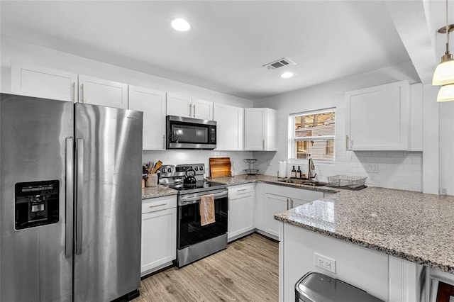 2912 Palm Dr, East Point, GA 30344 - kitchen featuring appliances with stainless steel finishes, a sink, white cabinetry, backsplash, and recessed lighting