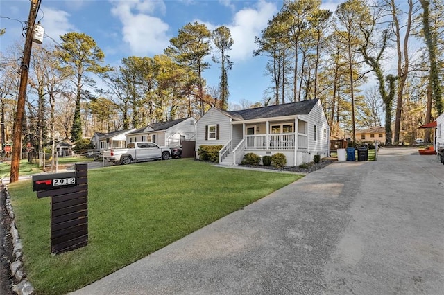 2912 Palm Dr, East Point, GA 30344 - view of front of house featuring covered porch, a front yard, and a residential view