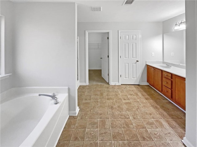 bathroom featuring vanity and a tub to relax in