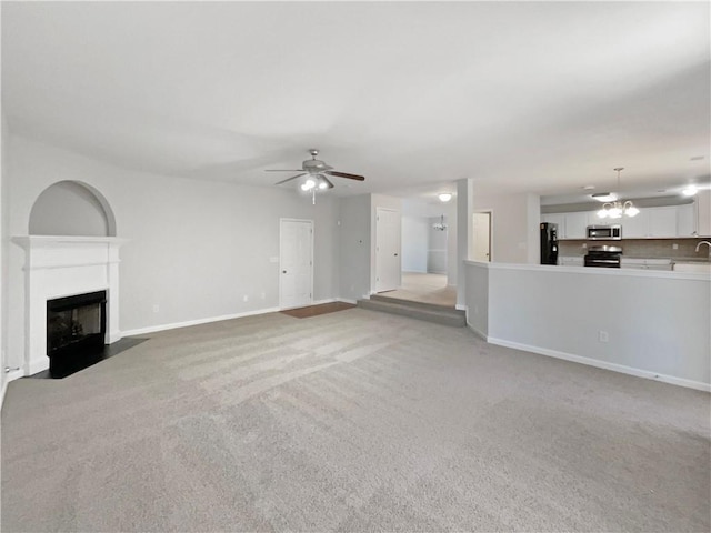 unfurnished living room with light carpet and ceiling fan