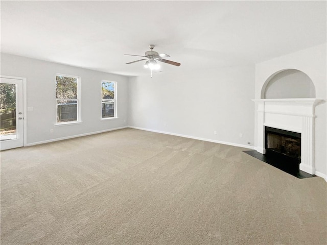 unfurnished living room featuring ceiling fan and carpet