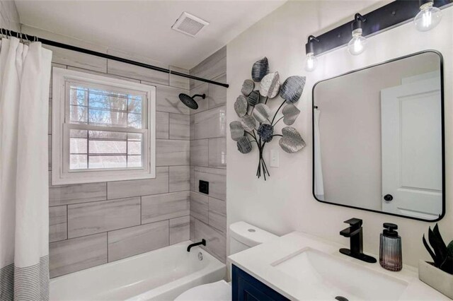 full bathroom featuring shower / tub combo, vanity, and toilet