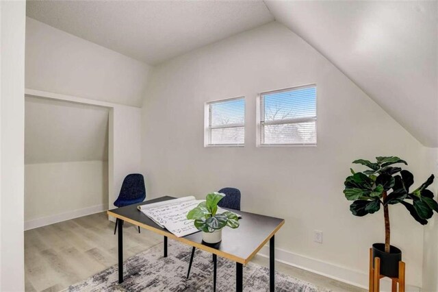 office area featuring wood-type flooring and lofted ceiling