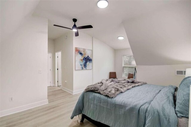 bedroom with light hardwood / wood-style floors, ceiling fan, and vaulted ceiling