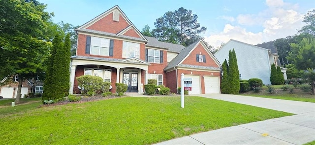 779 Avonley Creek Trce, Sugar Hill, GA 30518 - view of front of home with concrete driveway, brick siding, a garage, and a front yard