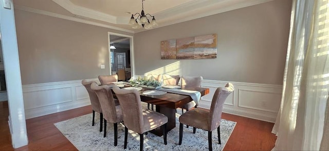 779 Avonley Creek Trce, Sugar Hill, GA 30518 - dining room with wood finished floors, crown molding, a decorative wall, a chandelier, and a wainscoted wall