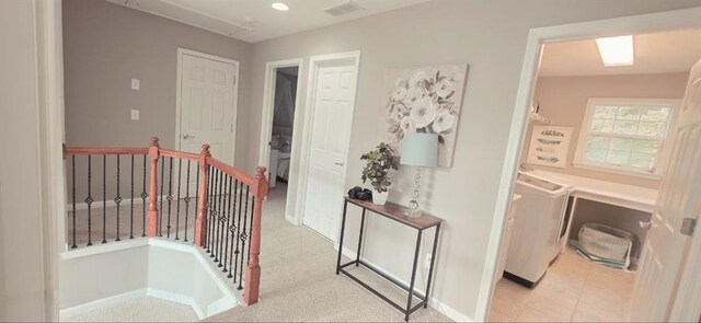 779 Avonley Creek Trce, Sugar Hill, GA 30518 - hallway with an upstairs landing, washer and clothes dryer, and baseboards