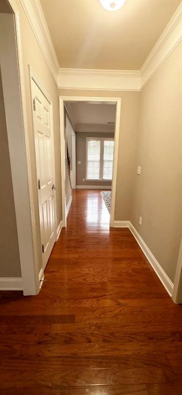 779 Avonley Creek Trce, Sugar Hill, GA 30518 - hallway featuring crown molding, wood finished floors, and baseboards