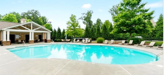 779 Avonley Creek Trce, Sugar Hill, GA 30518 - community pool with a patio area, an outbuilding, and view of wooded area