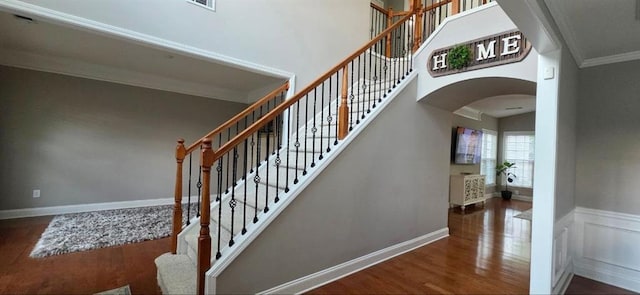 779 Avonley Creek Trce, Sugar Hill, GA 30518 - stairway with arched walkways, wood finished floors, crown molding, and a towering ceiling