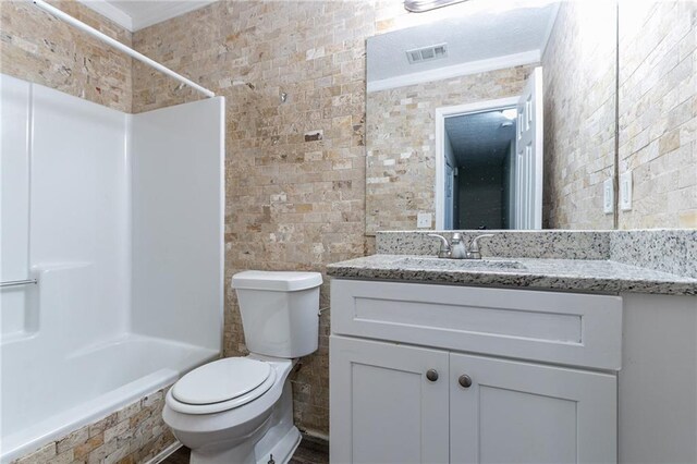 full bathroom featuring washtub / shower combination, vanity, tile walls, and ornamental molding