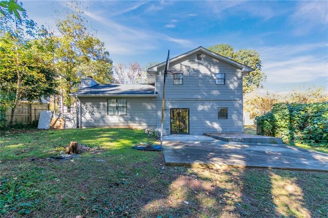 rear view of house featuring a yard and a patio