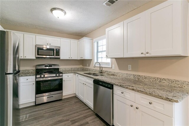 kitchen featuring white cabinetry, sink, and appliances with stainless steel finishes
