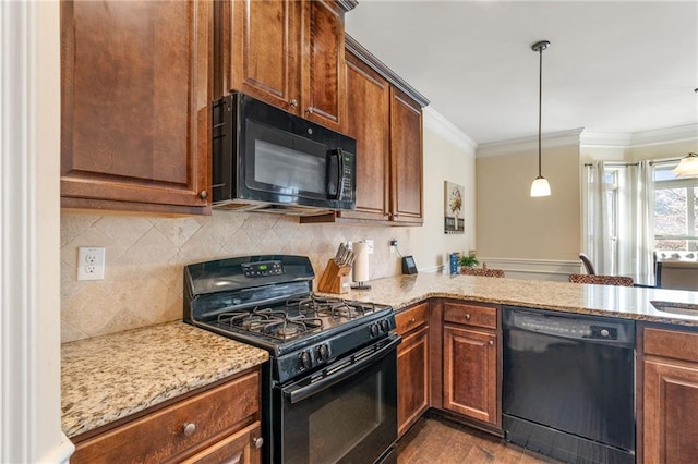 kitchen featuring light stone countertops, black appliances, pendant lighting, and crown molding