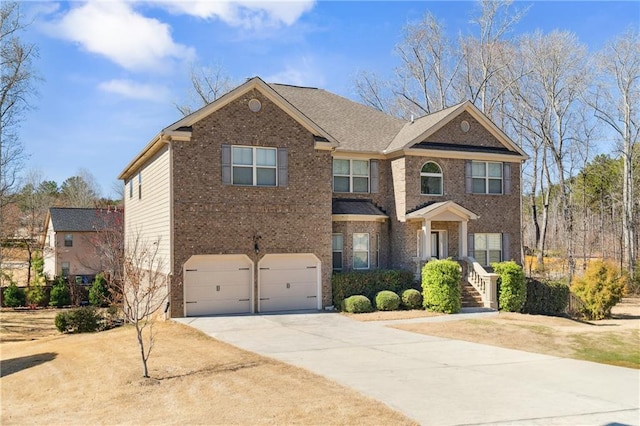 view of front of house featuring driveway, an attached garage, and brick siding