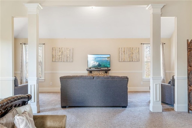 living area with lofted ceiling, ornate columns, and carpet floors