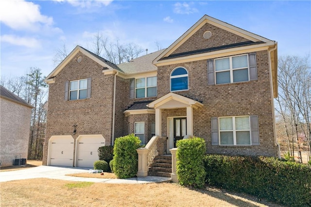 traditional home featuring driveway, brick siding, and a garage