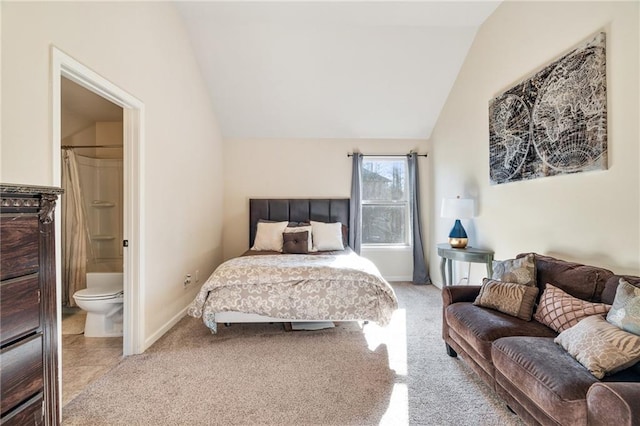 bedroom featuring lofted ceiling, light colored carpet, ensuite bathroom, and baseboards