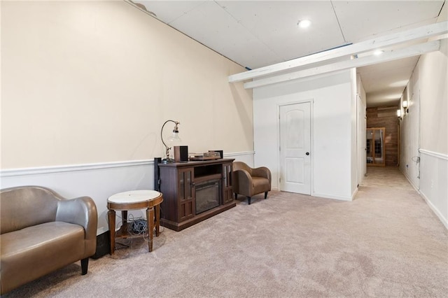 sitting room featuring baseboards and carpet floors