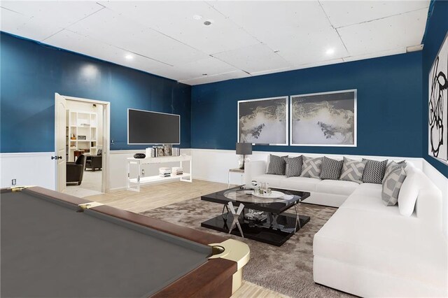 living area featuring a wainscoted wall and billiards