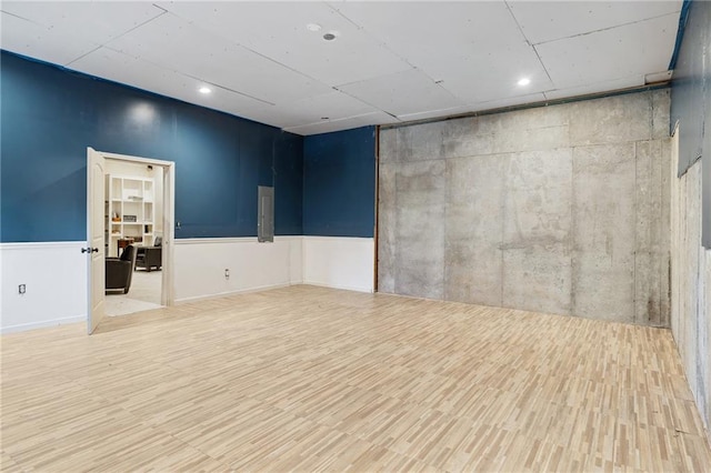 empty room with wainscoting and wood finished floors