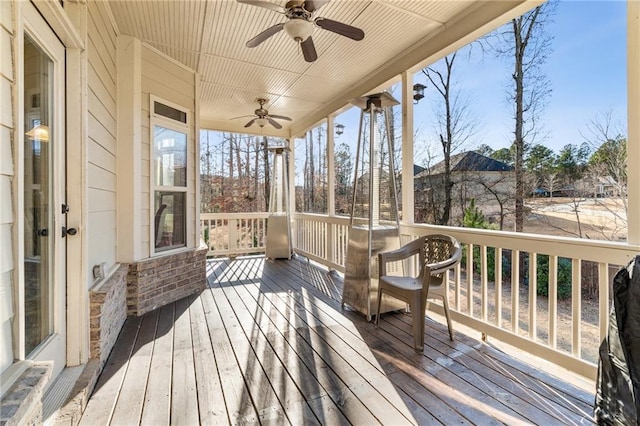 wooden deck with a ceiling fan
