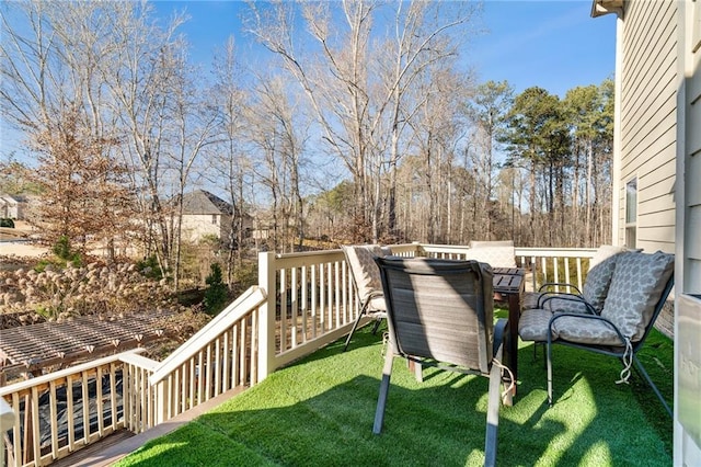 wooden terrace with a lawn